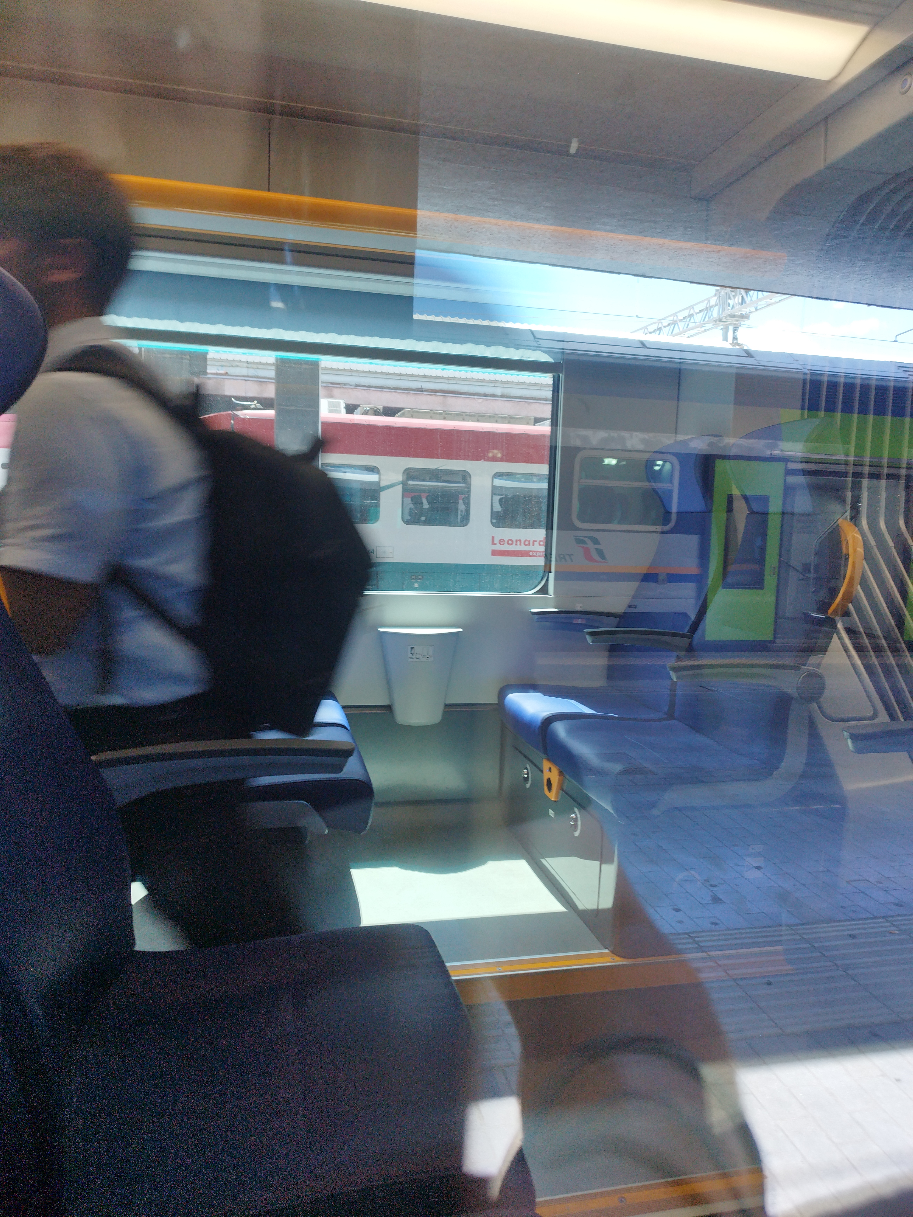Pop's train inside, showing new and clean seats through a window