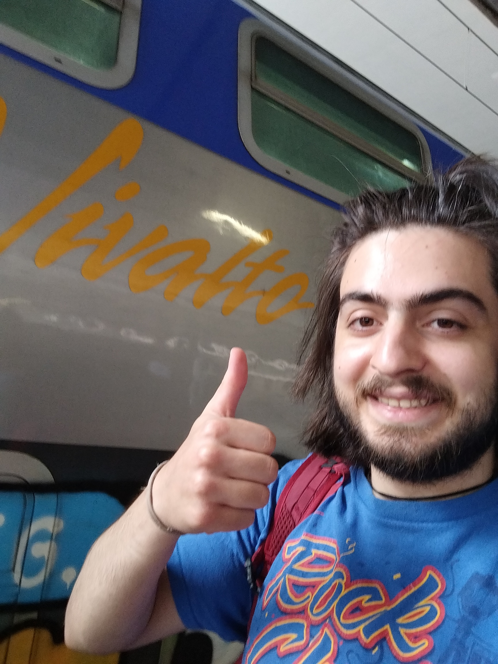 me and a Vivalto train logo behind me