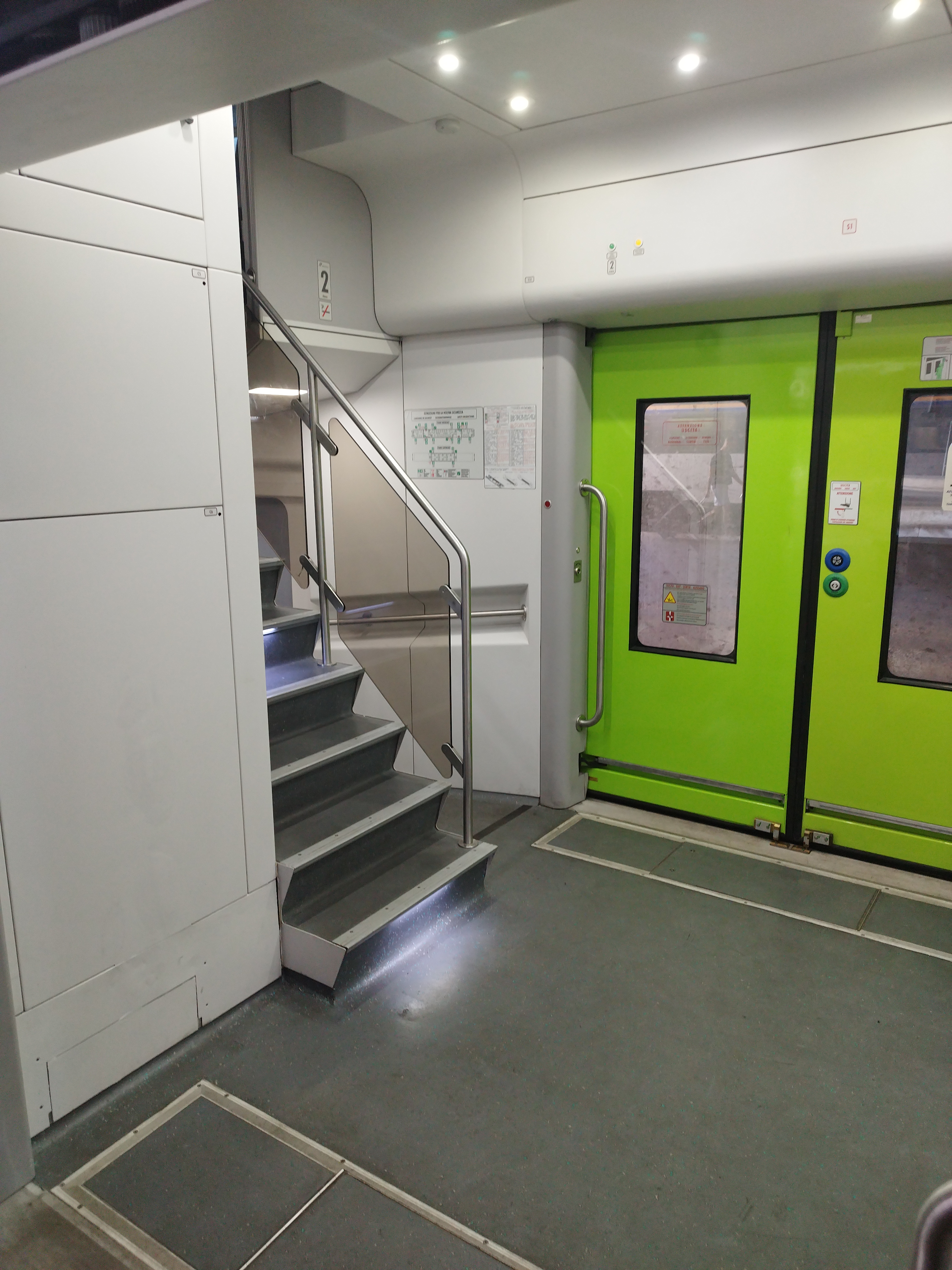 Vicalto's inside, showing a gray stair and green doors